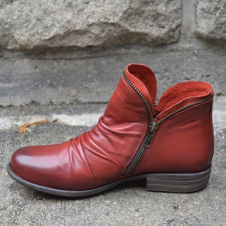 Stylish women's leather ankle boots with a low heel, ideal for versatile autumn footwear.
