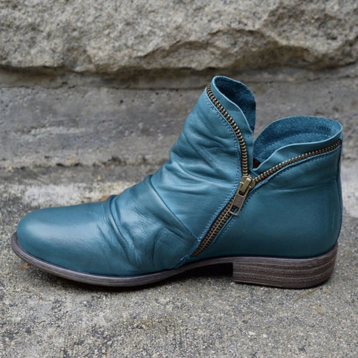 Pair of women's autumn footwear: sleek black leather ankle boots for a stylish look.