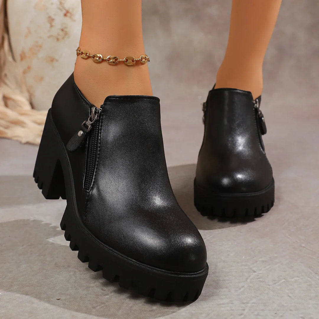 Close-up of the block heel on women's leather dress shoes, emphasizing stability