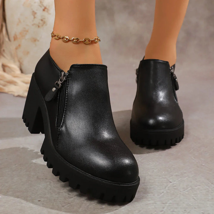 Close-up of the block heel on women's leather dress shoes, emphasizing stability