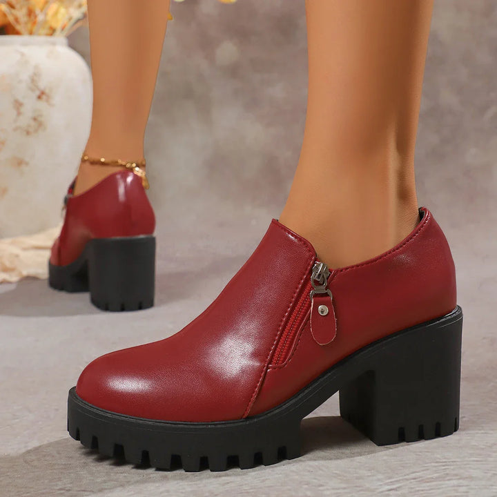 Side view of women's leather block heel dress shoes, showcasing their elegant design