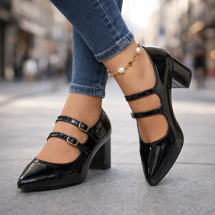 Women's black leather block heel pumps with dual buckle straps, elegant dress shoes