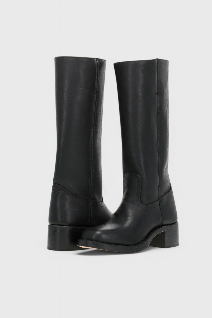 Close-up of women's black leather knee-high boots, highlighting the quality material and stitching.