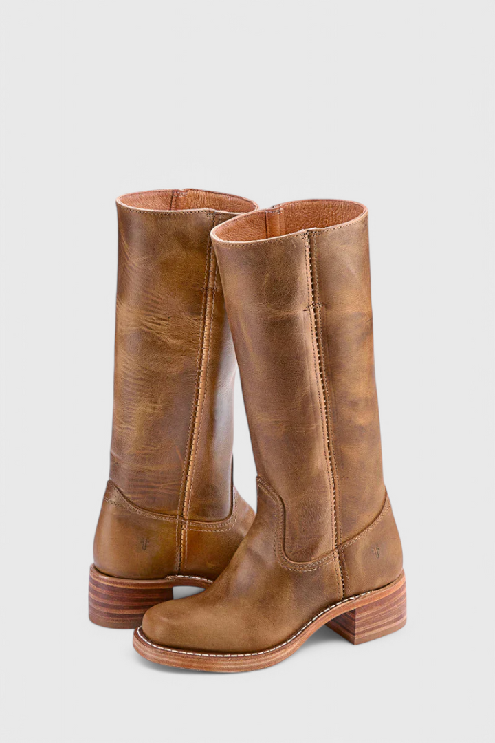 Woman wearing versatile knee-high leather boots with a dress, a chic fall look.
