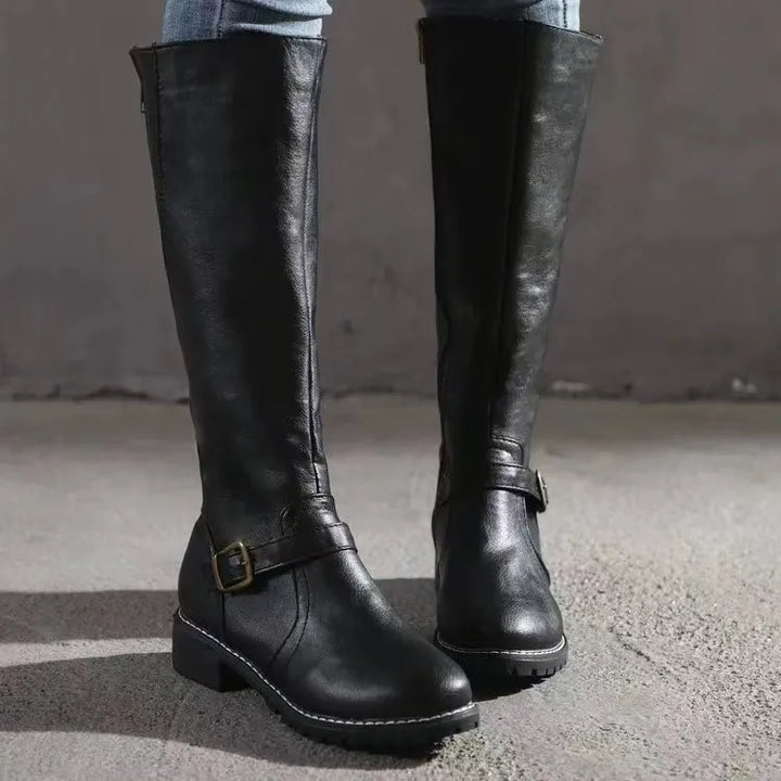 Side view of a women's orthopedic leather boot, showcasing the comfortable design and sturdy block heel.