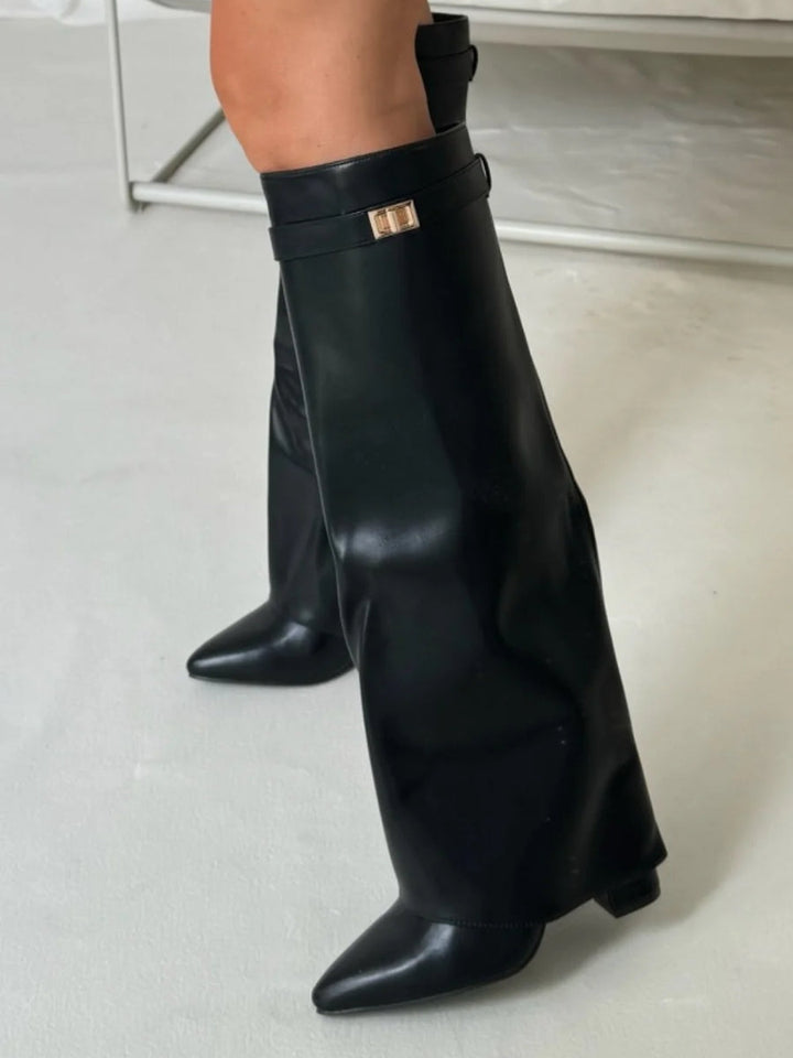 Studio shot of women's sleek black leather thigh-high boots, showcasing classic buckle design.