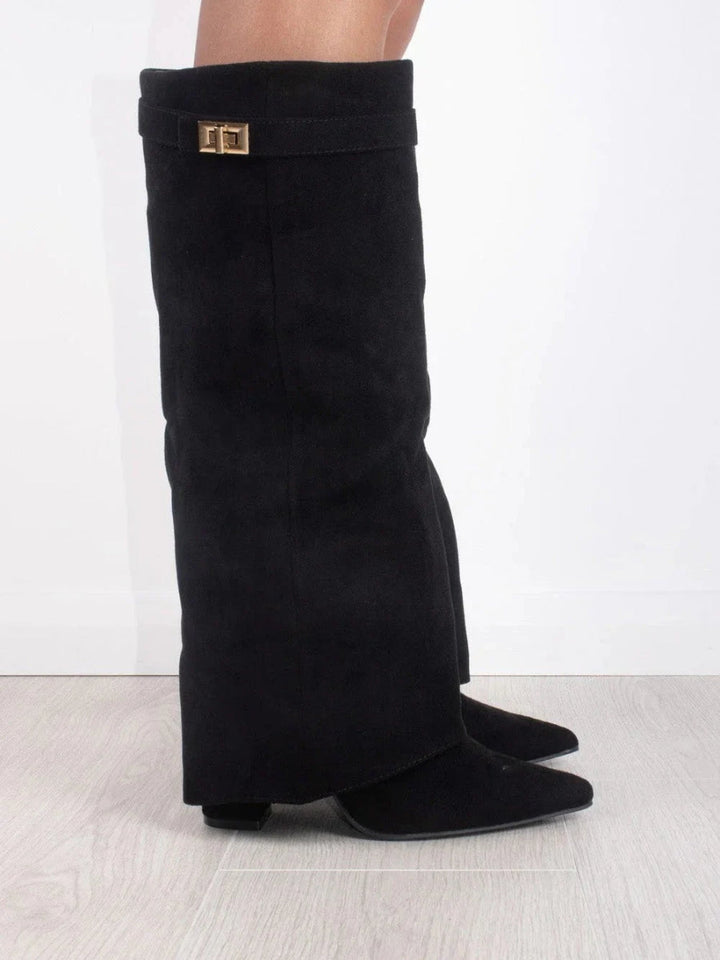 Stylish women's thigh-high leather boots featuring decorative buckle straps and a sleek design.