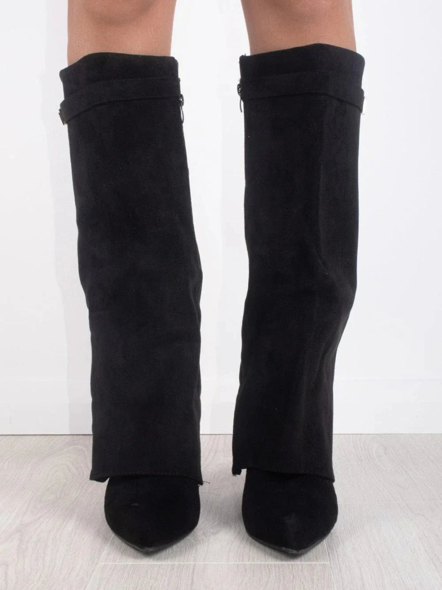 Side profile of women's tall leather boots with multiple buckles, ideal for a chic winter look.