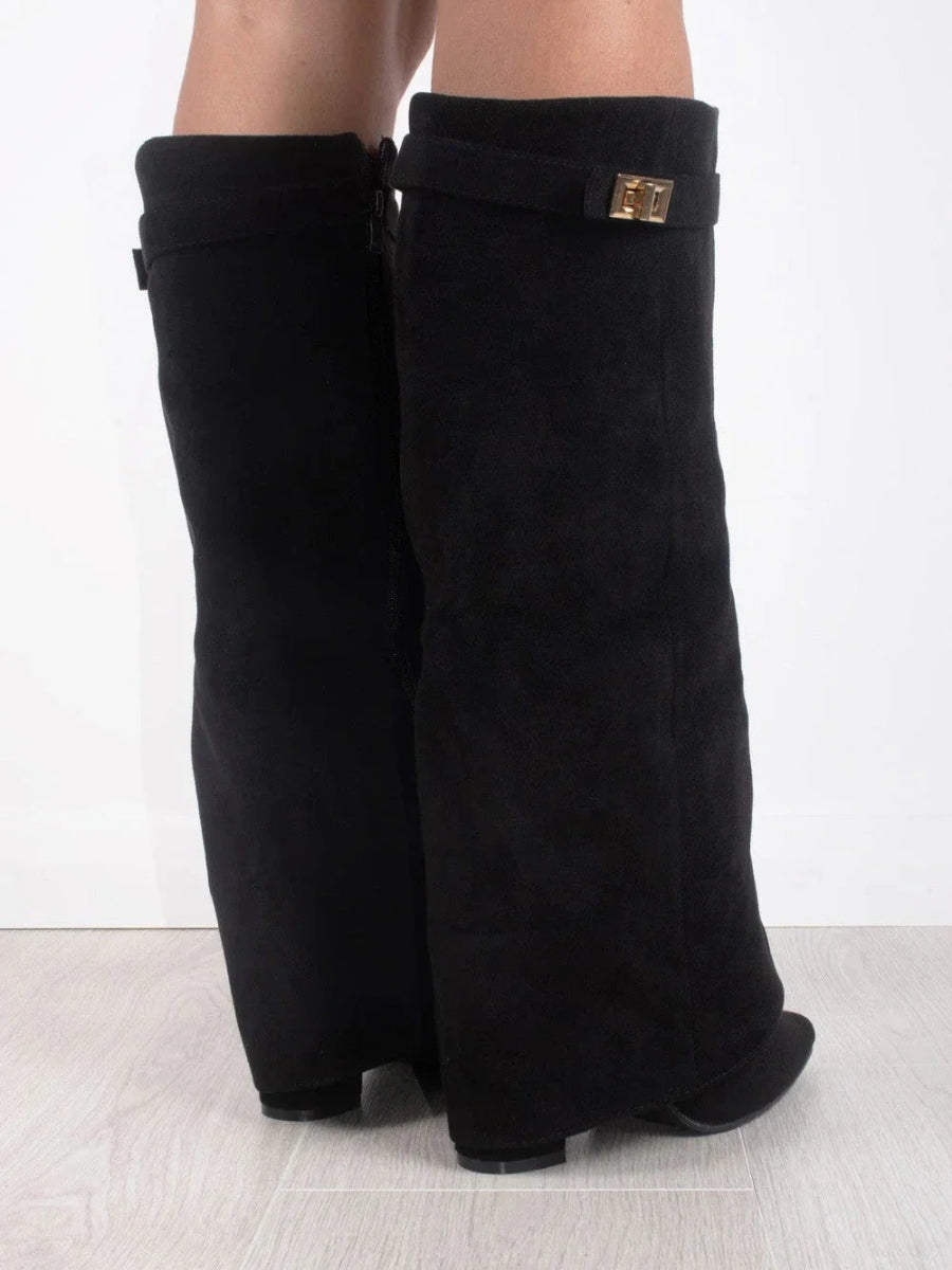 Close-up of the buckle detail on women's elegant leather thigh-high boots, high fashion footwear.