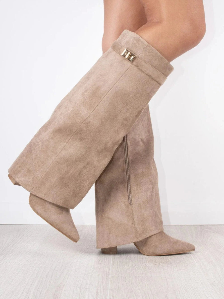 Women's black suede thigh-high boots with silver buckle accents, a sophisticated winter boot.