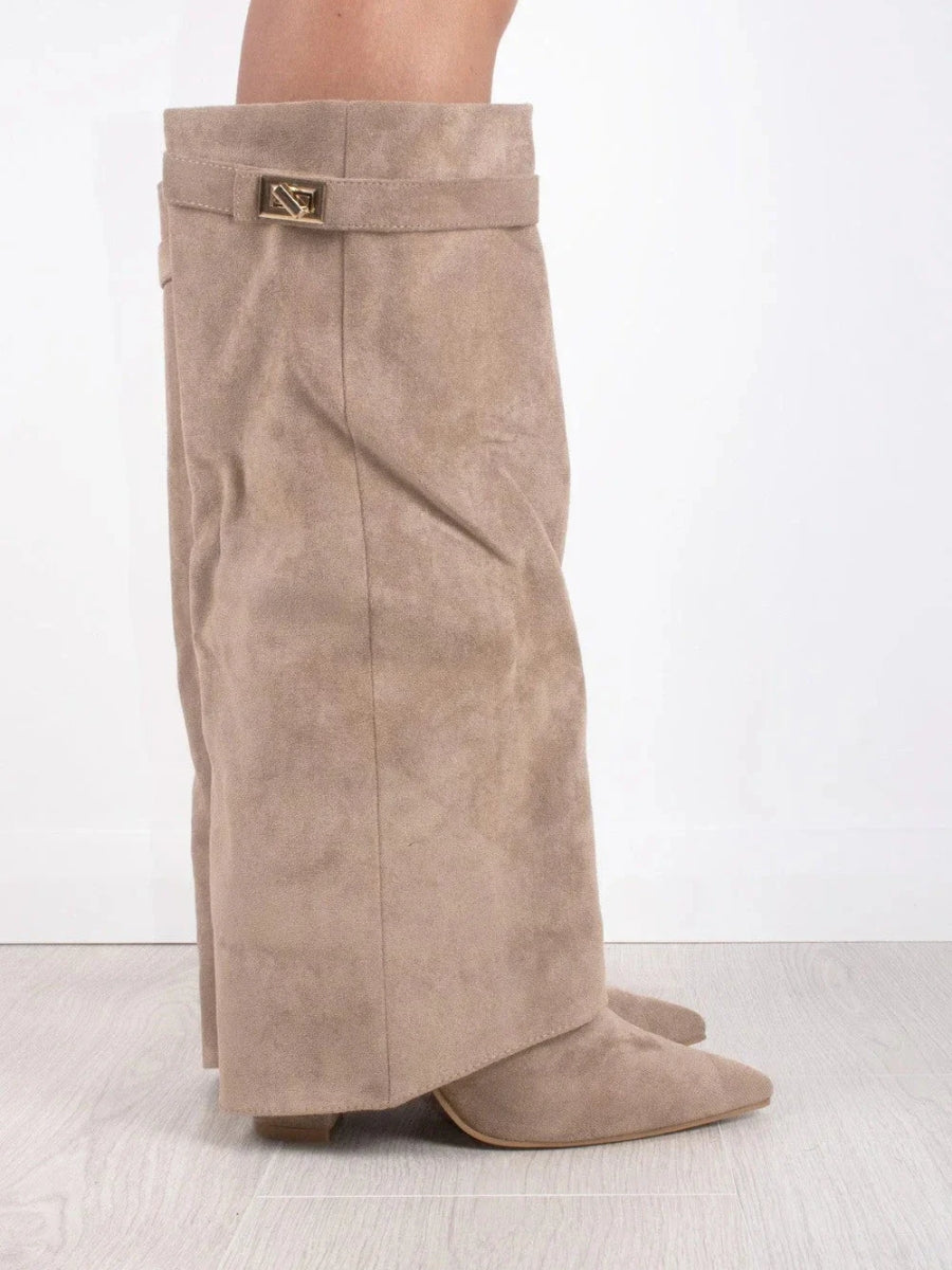 Full length shot of women's attractive leather thigh-high boots, highlighting the buckle design.