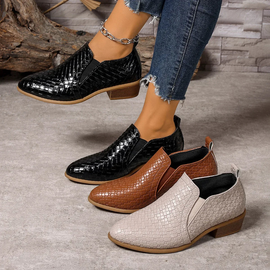 Detailed shot of the woven leather on a women's slip-on ankle boot, highlighting craftsmanship and texture.