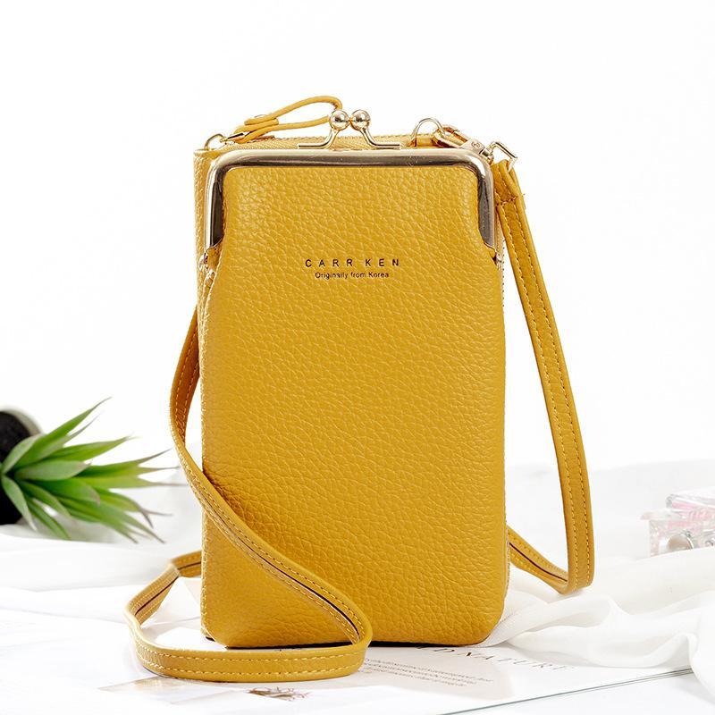 Women's small crossbody bag with adjustable strap, lying flat, showcasing its minimalist aesthetic
