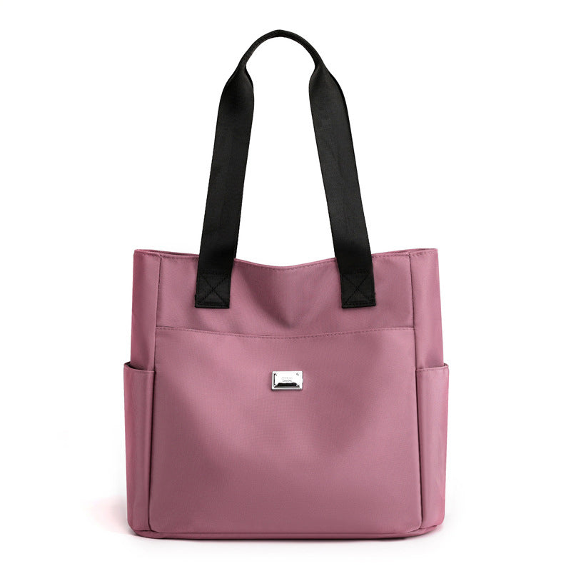 Women's multi-pocket nylon handbag with a sleek, waterproof finish, perfect for all weather