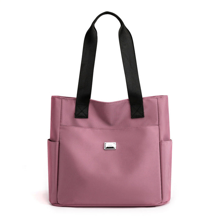 Women's multi-pocket nylon handbag with a sleek, waterproof finish, perfect for all weather