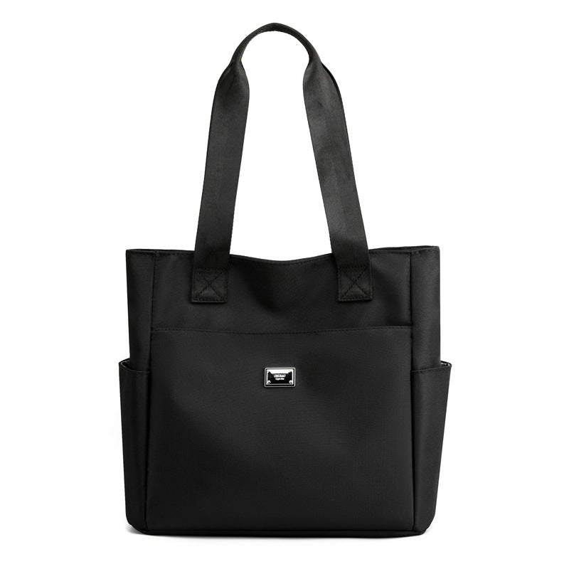 Collection of various items inside the women's multi-pocket nylon travel bag, organized contents
