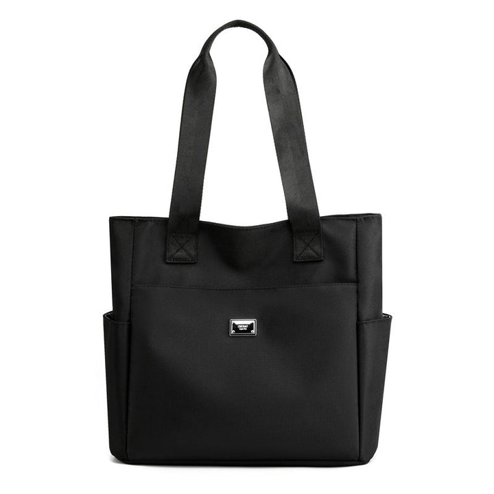 Collection of various items inside the women's multi-pocket nylon travel bag, organized contents