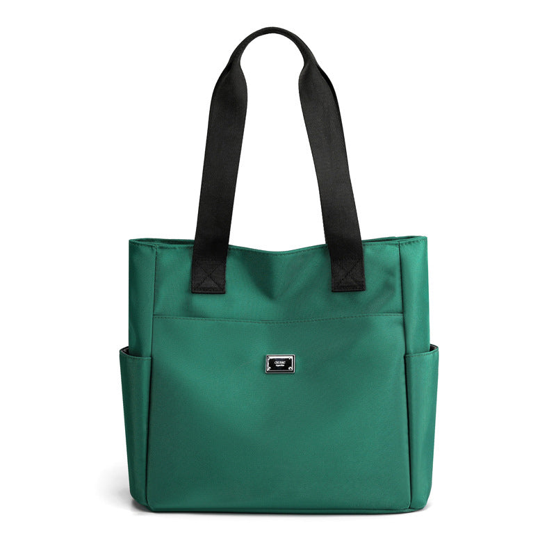 Lifestyle image of women's multi-pocket nylon work bag in an urban setting, everyday use
