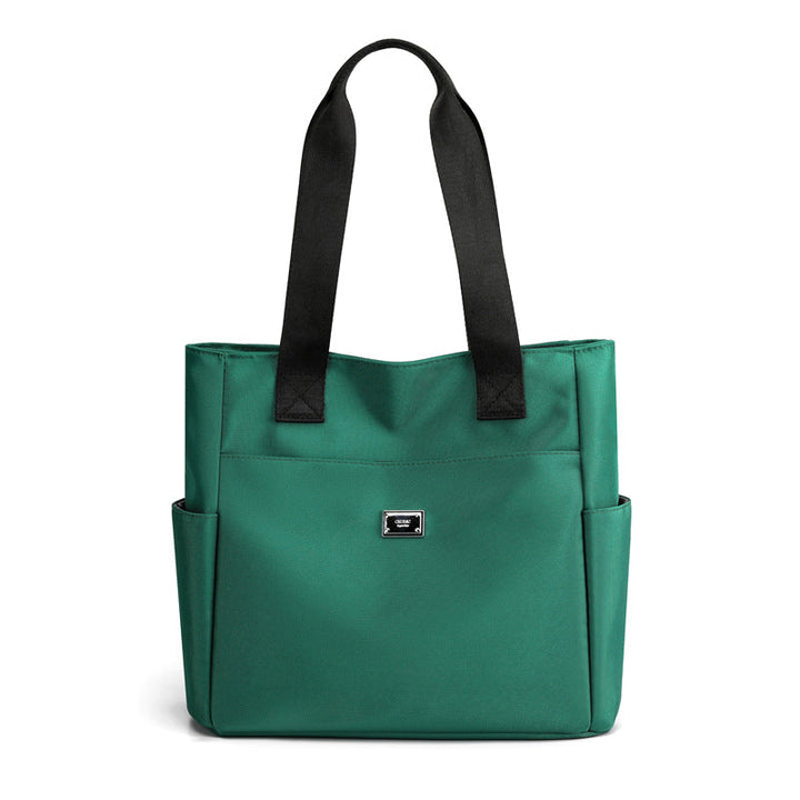 Lifestyle image of women's multi-pocket nylon work bag in an urban setting, everyday use