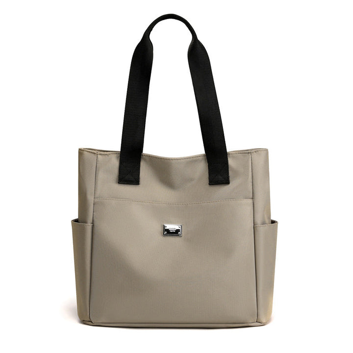Zoomed shot of the multi-pocket detail on the front of the women's waterproof nylon shoulder bag