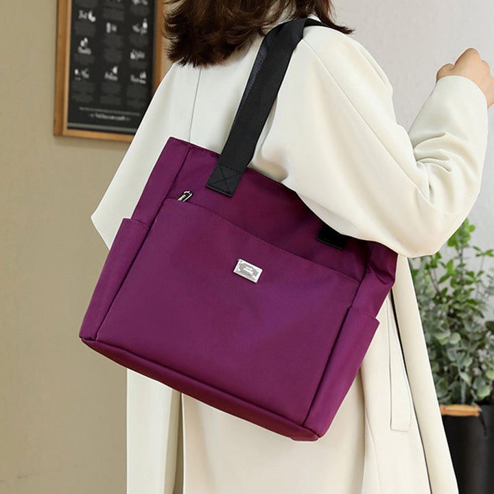 Stylish women's large capacity nylon shoulder bag with multiple compartments, waterproof design