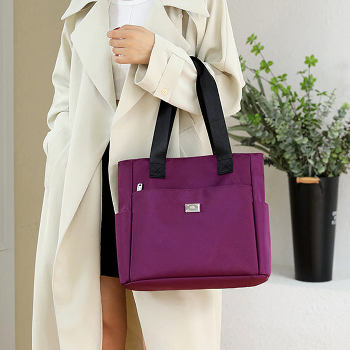 Side view of the women's multi-pocket waterproof nylon shoulder bag, highlighting its spaciousness