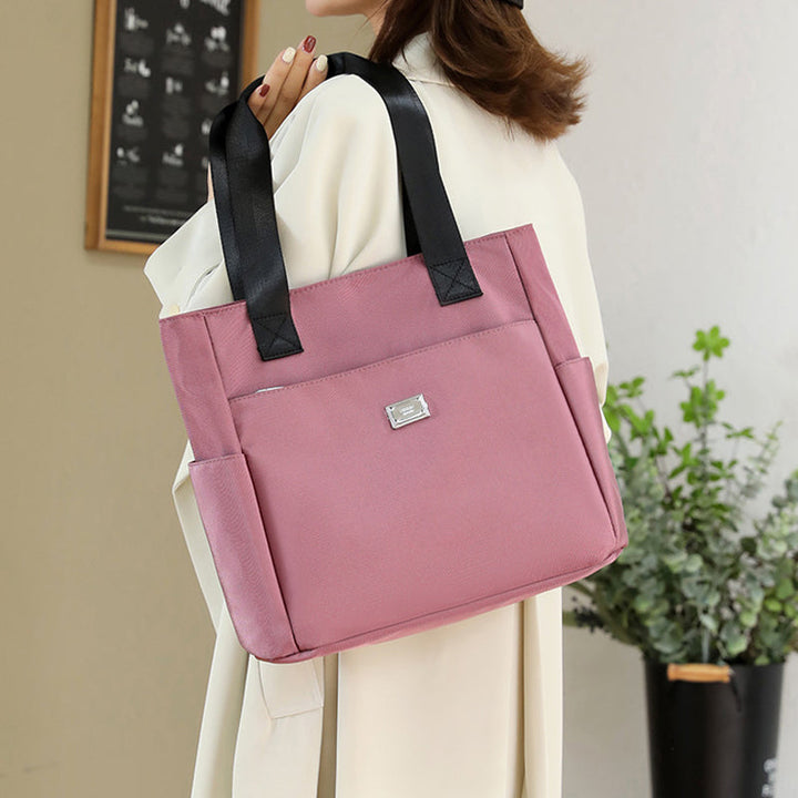 Back of women's nylon shoulder handbag with an extra zippered pocket, perfect for security
