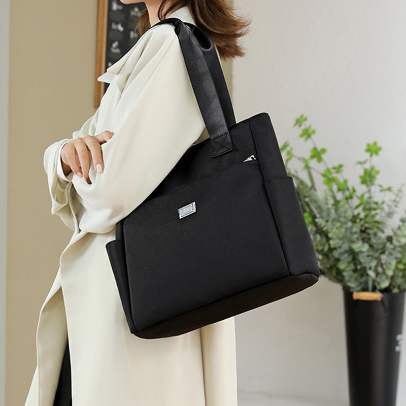 Detail of the adjustable strap on a women's multi-pocket nylon shoulder bag, versatile carry