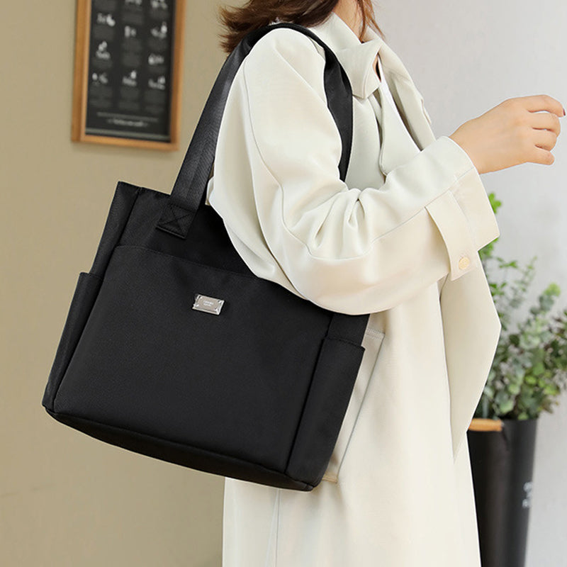 Interior view of the women's large capacity nylon shoulder bag, organized compartments shown
