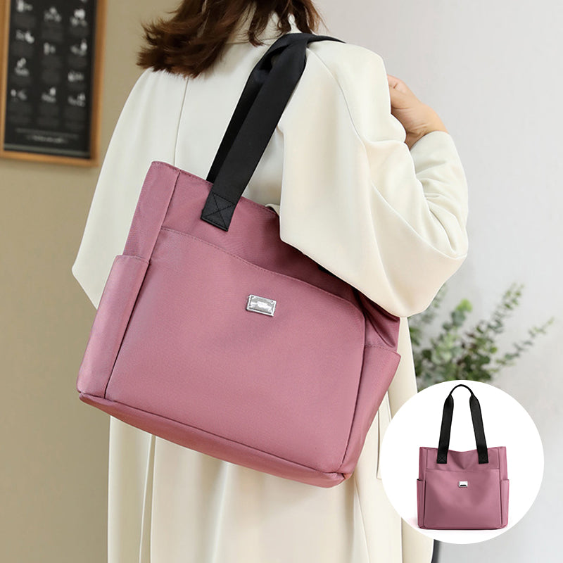Women's black nylon travel bag with multiple exterior pockets, waterproof & practical design