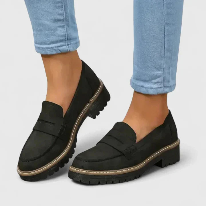 Women's black orthopedic loafers with arch support, perfect for all-day comfort and professional wear.