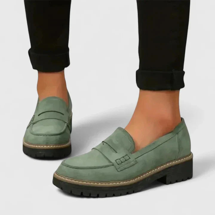 Close-up of women's black orthopedic loafers, highlighting built-in arch support for ultimate all-day comfort footwear.