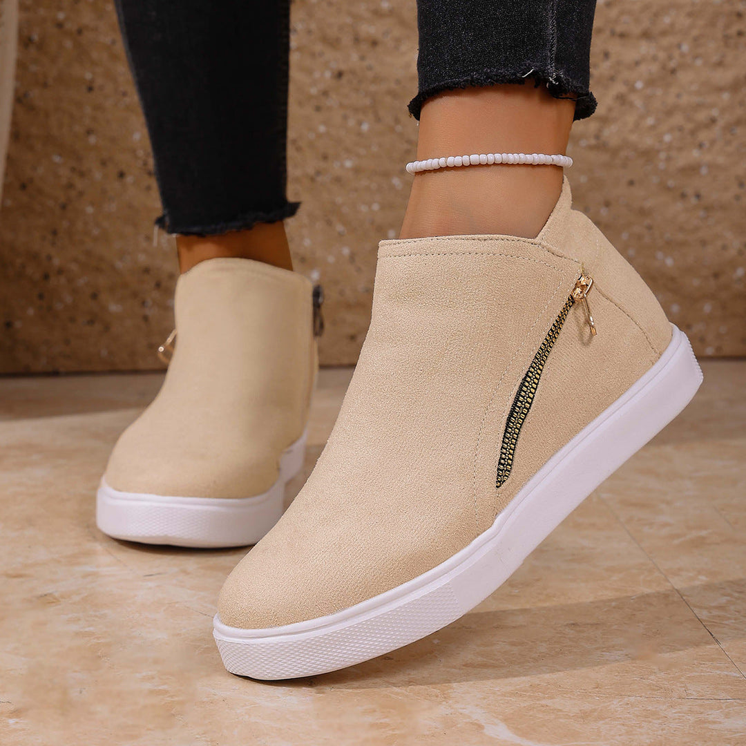 Pair of women's comfort sneakers with orthopedic support, featuring a stylish zip closure.