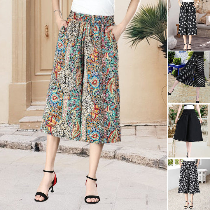Women's black pleated wide leg culottes, high elastic waist, chiffon fabric, ideal for casual summer wear.