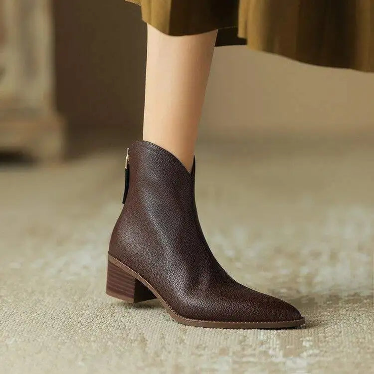 Women's black pointed toe ankle boots with low heel, slip-on style.