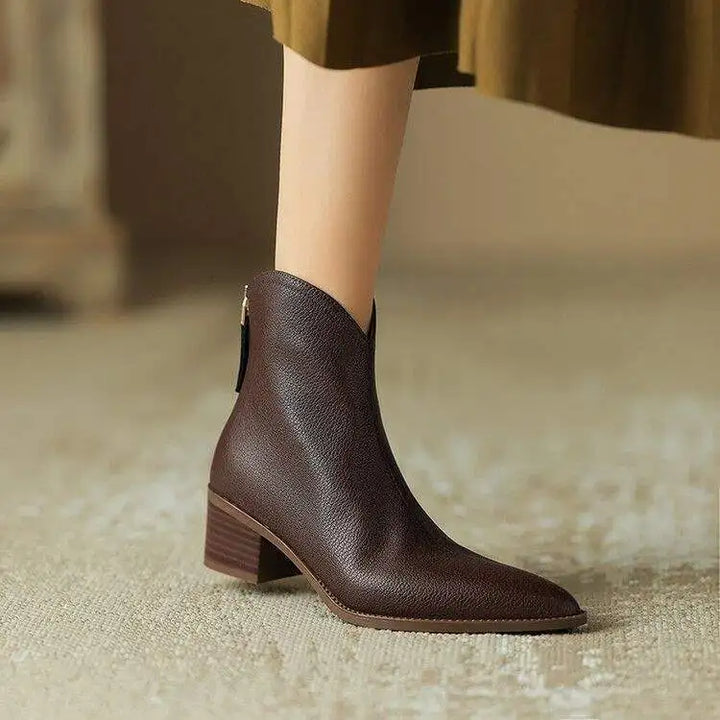 Women's black pointed toe ankle boots with low heel, slip-on style.