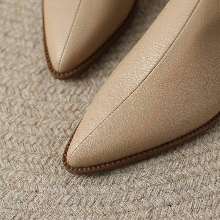 Easy slip-on women's pointed toe ankle boots with comfortable low heel.