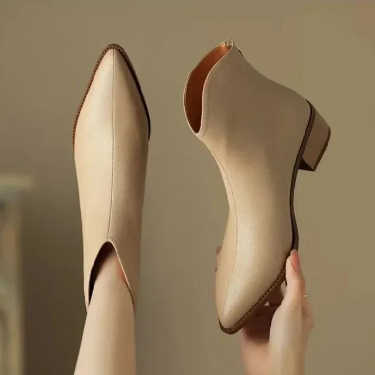 Beige women's slip-on ankle boots, pointed toe, low heel, a modern elegant choice.