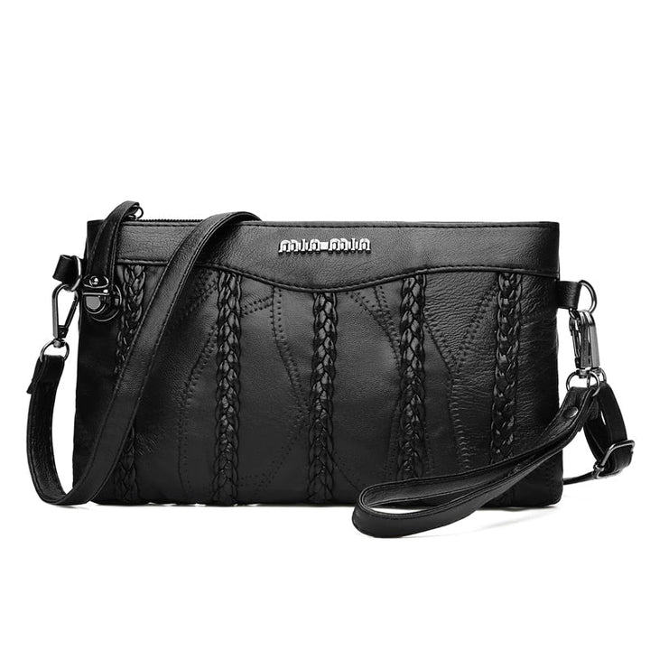 Women's black PU leather crossbody clutch bag with spacious interior and gold-tone hardware, elegant design.
