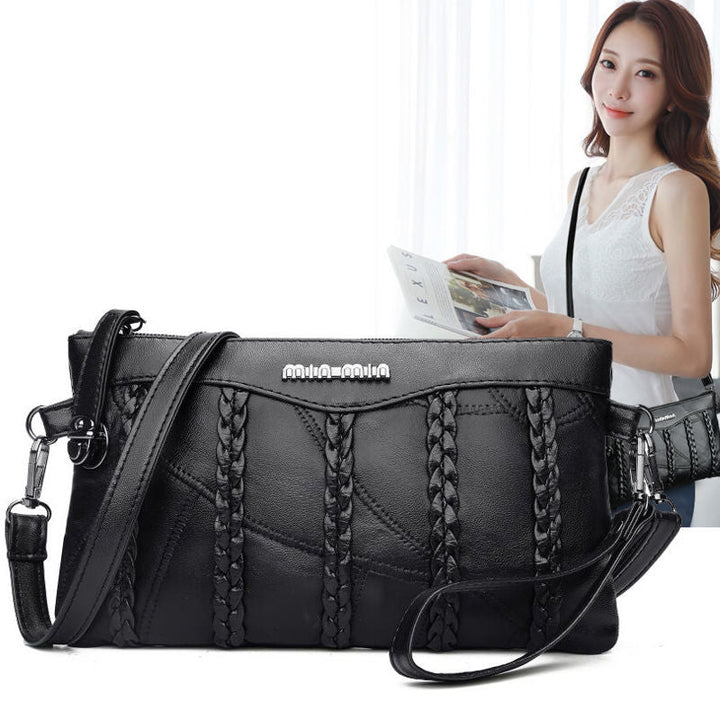 Women's PU leather crossbody clutch bag in sleek black, offering a spacious and organized interior for daily carry.