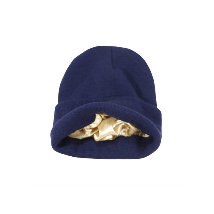 Model wearing a white satin-lined winter beanie, demonstrating its comfort and style