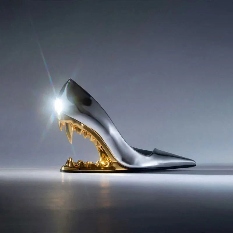 Pair of unique black women's pumps featuring an architectural fang heel, front view.