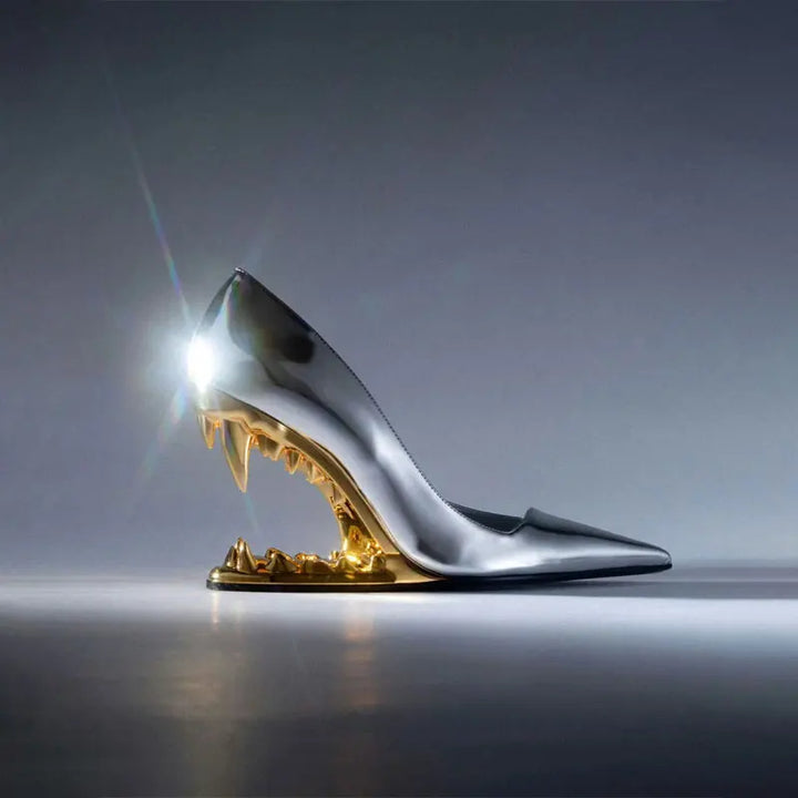Pair of unique black women's pumps featuring an architectural fang heel, front view.