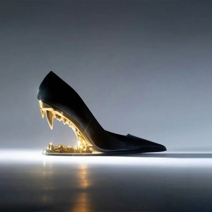 Side view of women's designer pumps with an edgy sculpted fang heel, showcasing the unique angle.