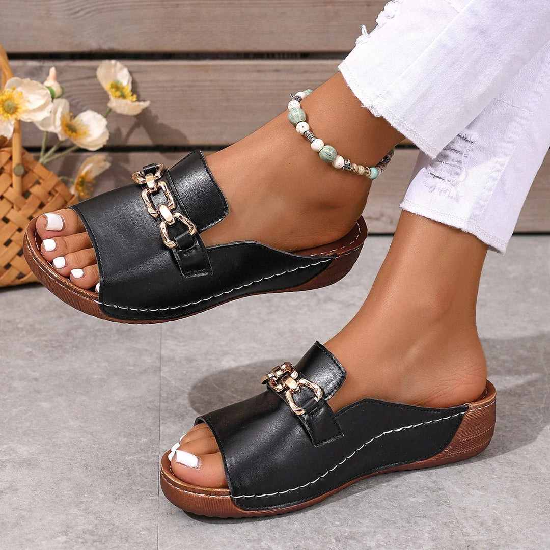 Casual black slip-on sandals for women, featuring a chic chain across the top