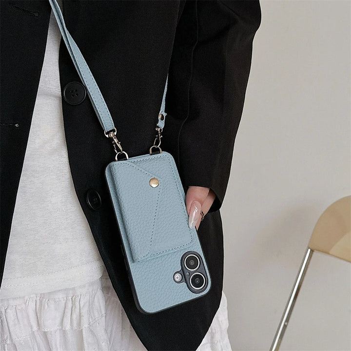 Open view of a grey vegan leather phone case and wallet with lanyard, showing interior compartments