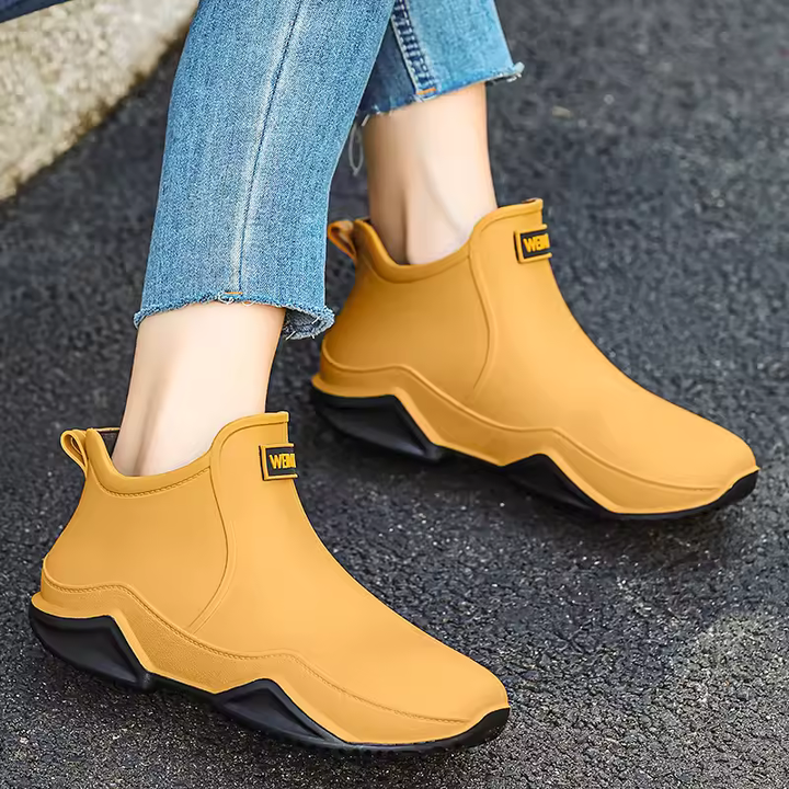 Women's black waterproof slip-on ankle rain boots, perfect for puddle-proof weather protection.