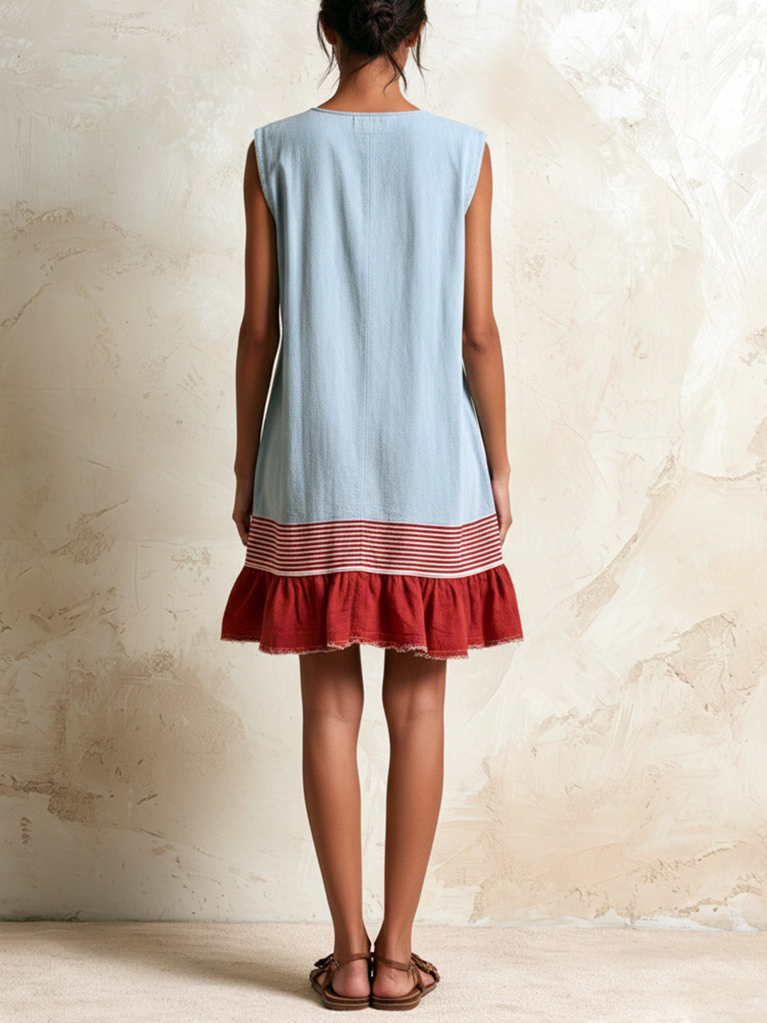 Women's blue tiered ruffle mini dress featuring a sleeveless design and chic contrast hem.