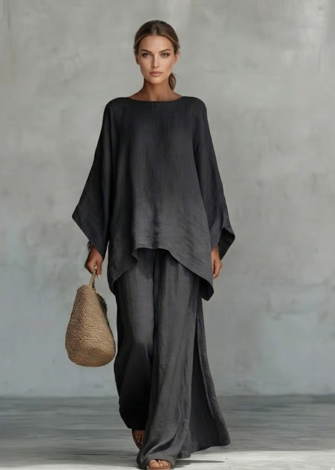 Elegant women's two-piece ensemble: stylish cape top & wide-leg pants for a sophisticated bohemian chic look.