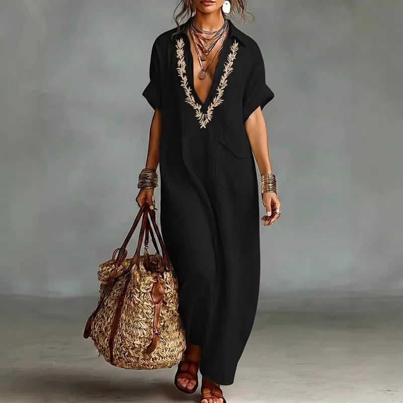 Vibrant bohemian printed maxi dress for women. Deep V-neck, flowing fabric, great for summer, beach, or casual.
